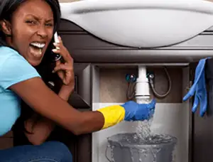 Emergency plumbing repair for a leaking sink drain under a bathroom vanity in Stockton, CA