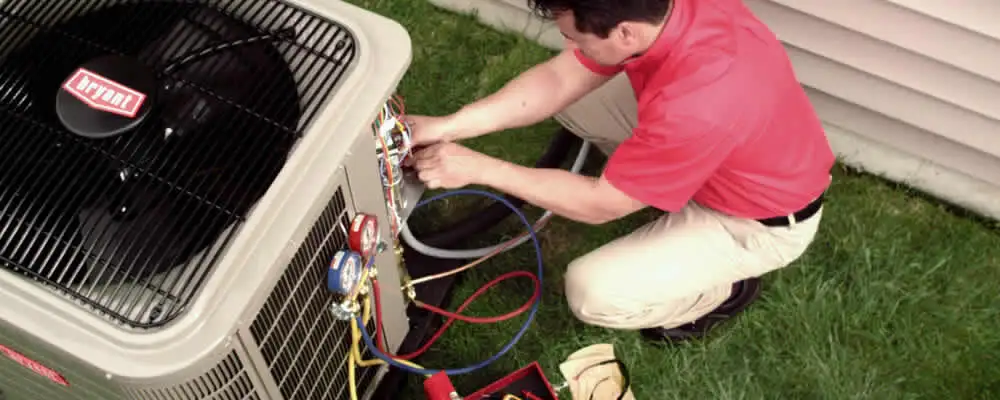 HVAC technician servicing an outdoor air conditioner unit in Stockton, CA