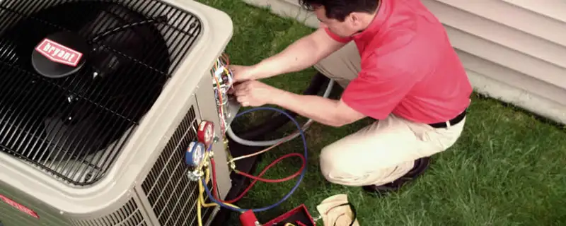 HVAC technician servicing an outdoor air conditioner unit in Stockton, CA