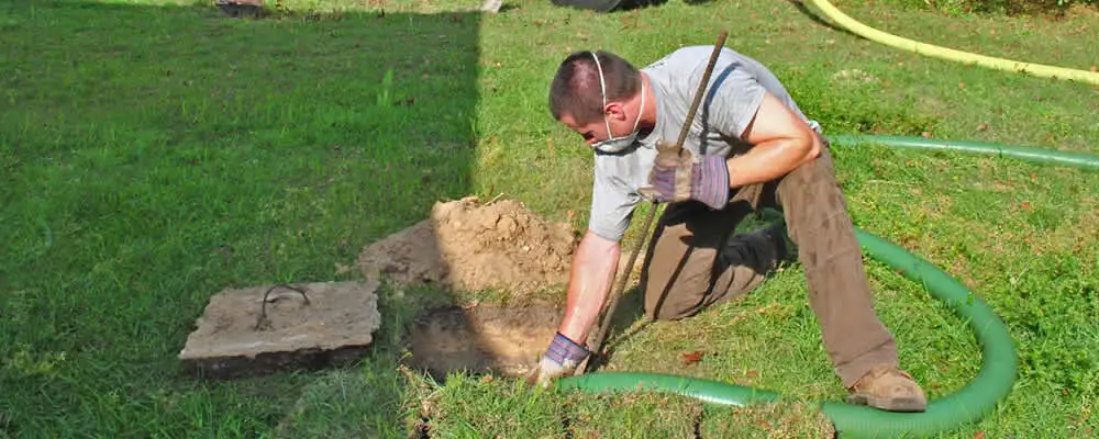 Septic pumping technician servicing a residential septic tank in Stockton, CA