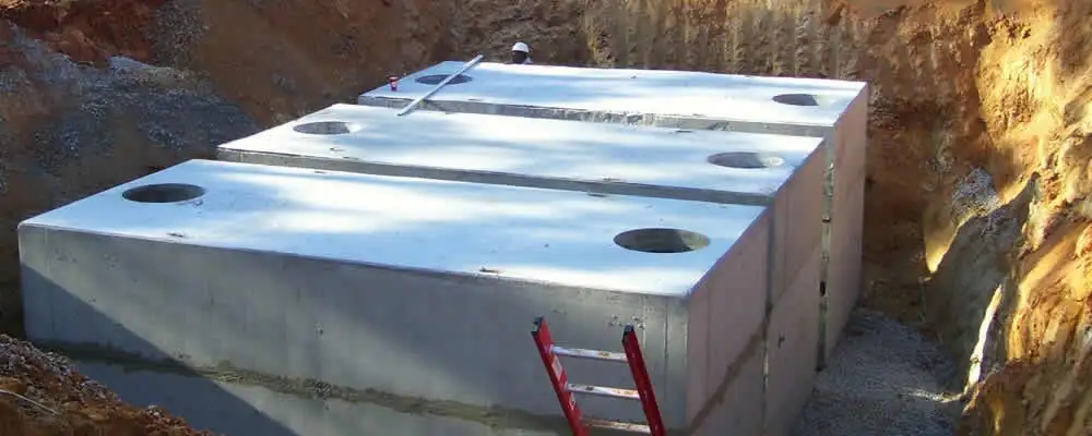 Septic tank installation site with a newly placed concrete tank in Stockton, CA